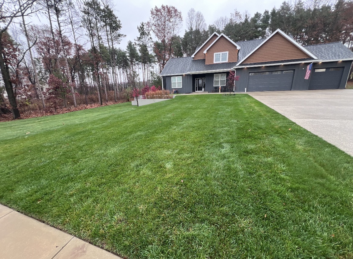 Well-maintained green lawn and home in Bangor, MI after a JR Landscaping fall cleanup