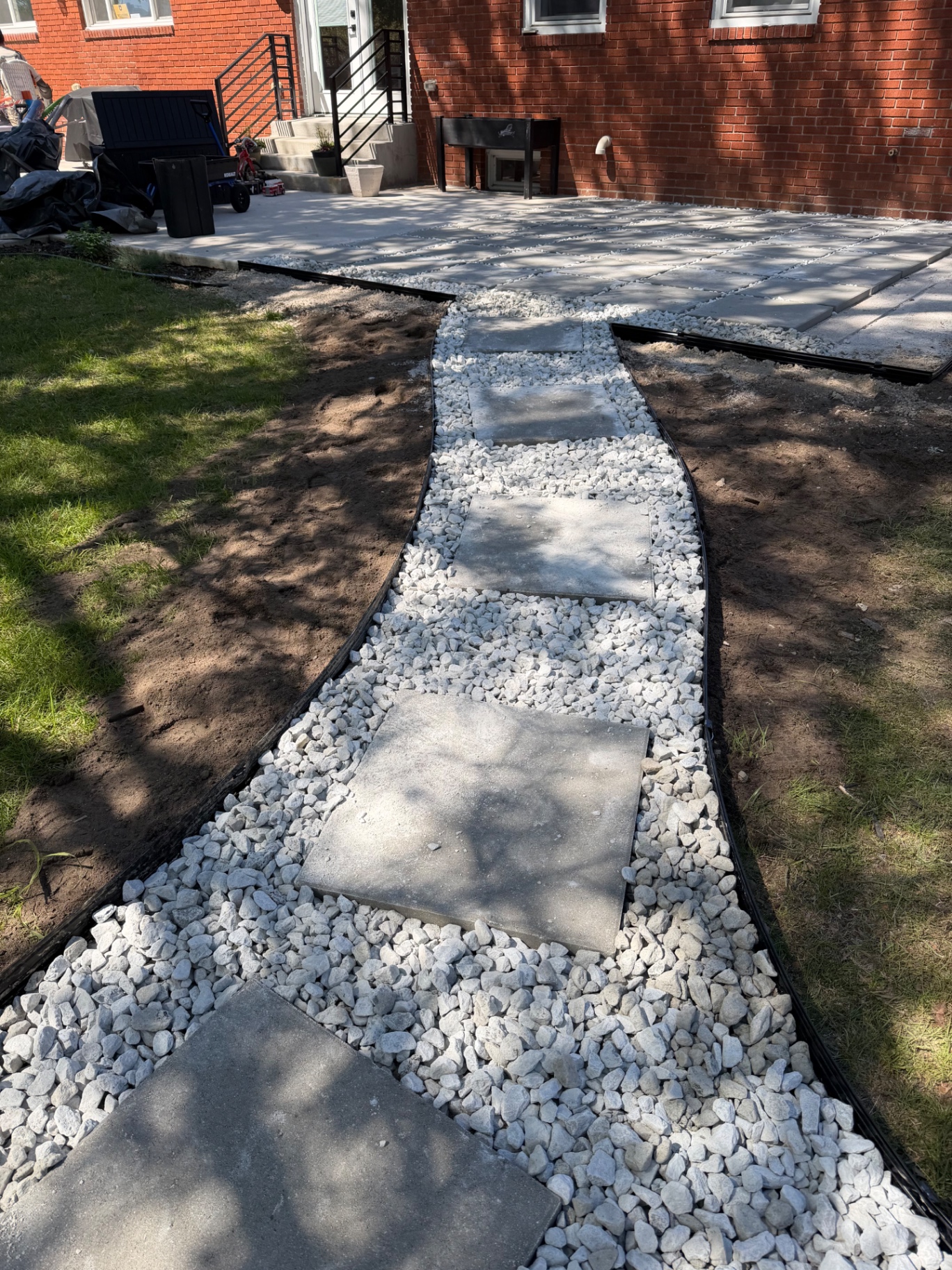 Stepping stone walkway through white river rock