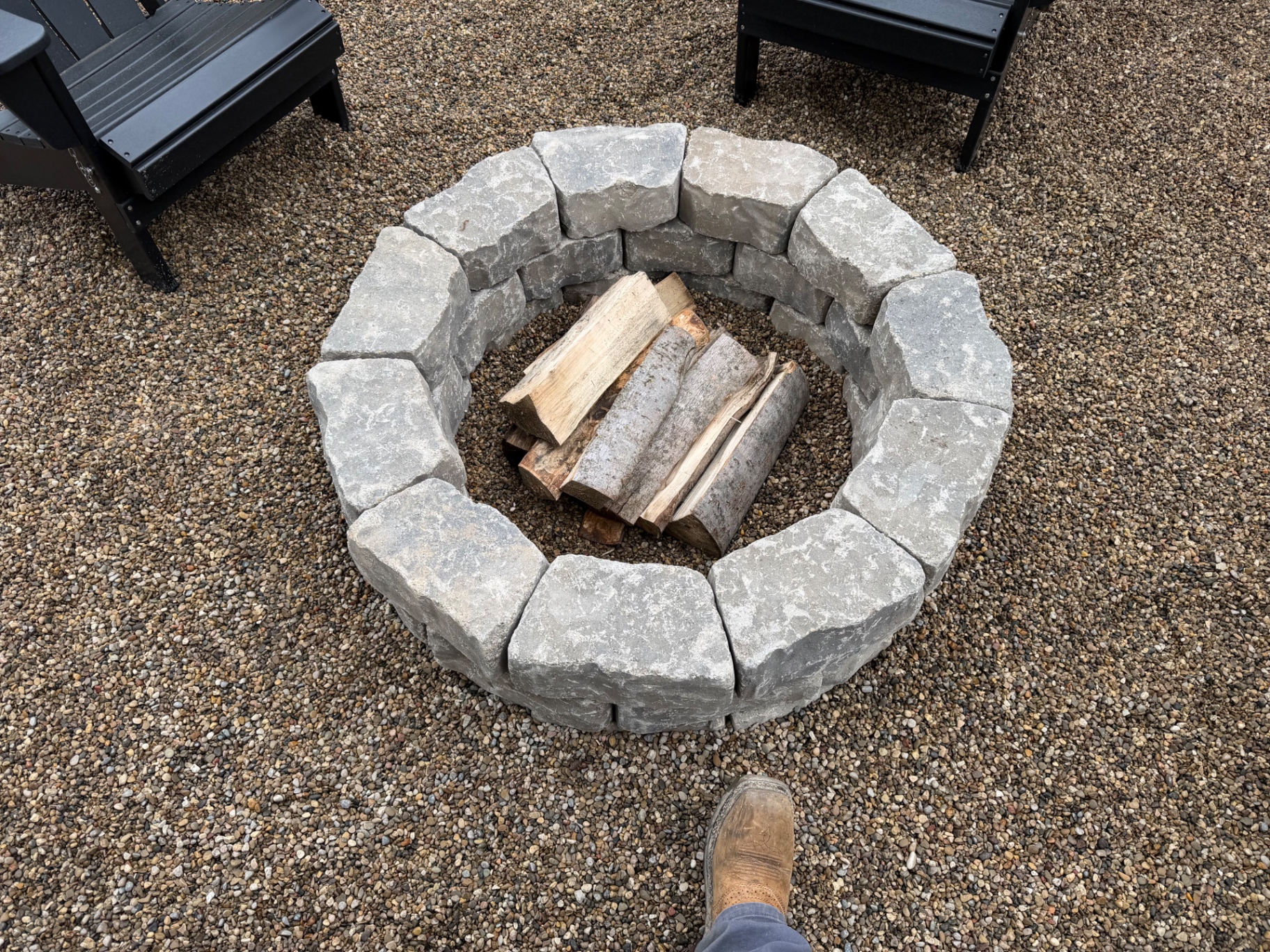 Close up of stacked stone fire pit with firewood