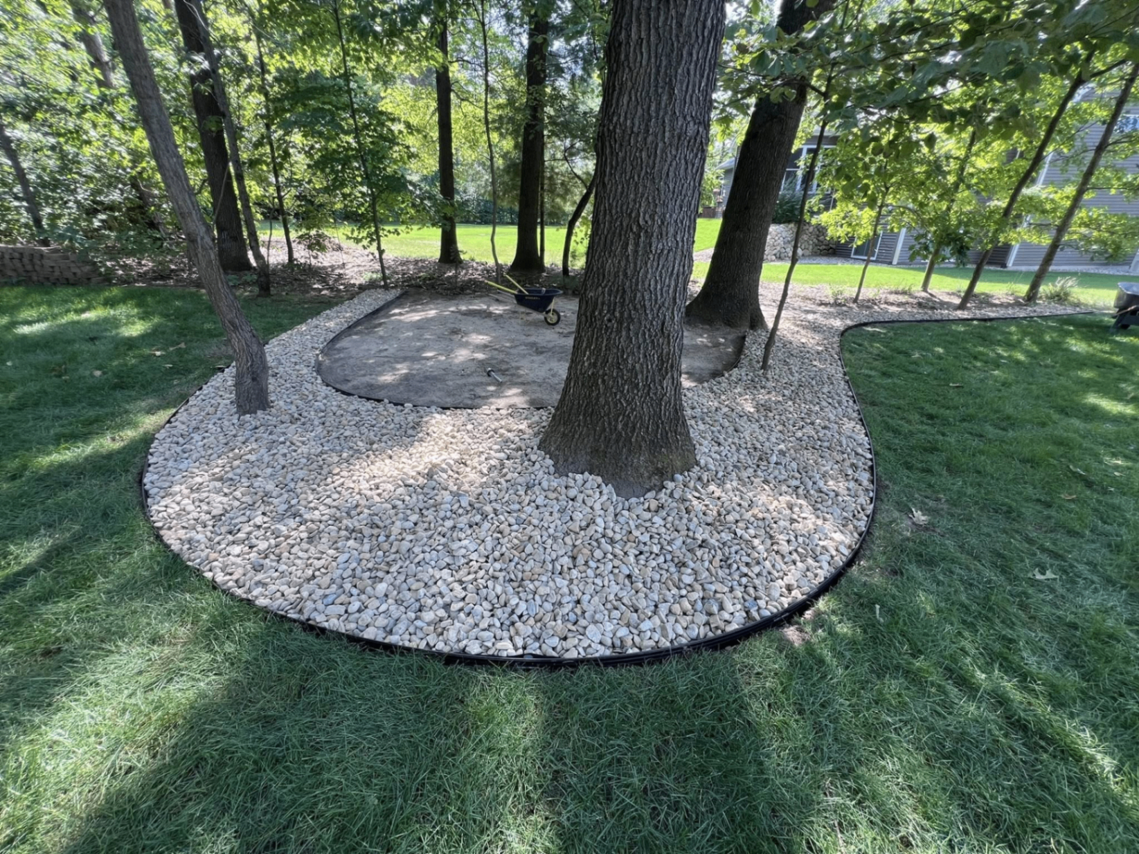 Decorative stone bed around mature trees